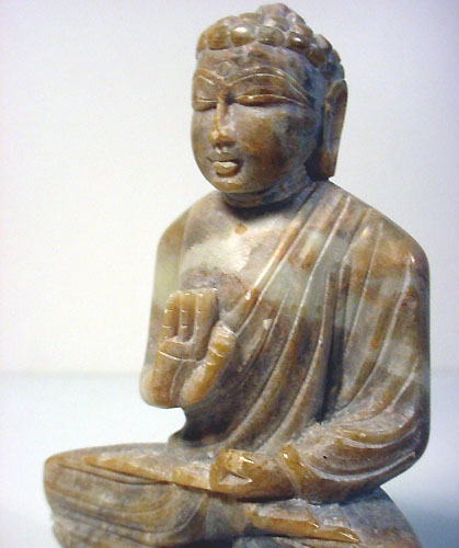 Buddha handcarved from marble stone into buddha statue gesture of protection